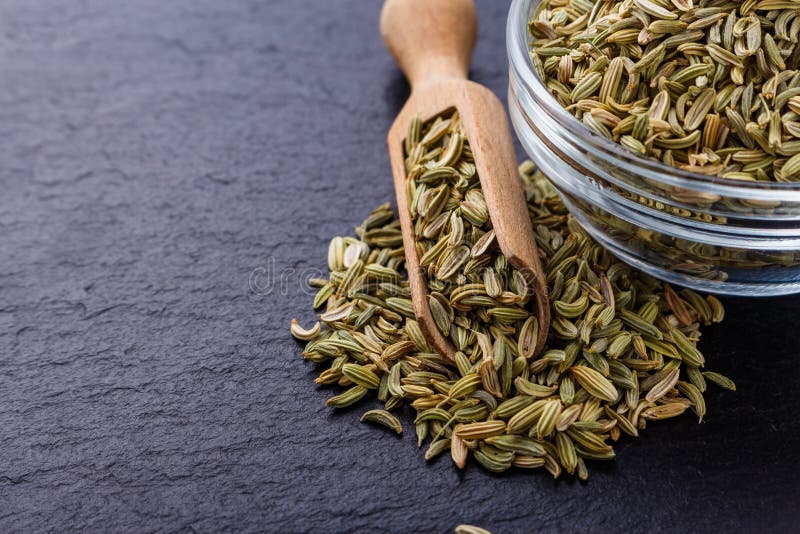 Essential Oil of Fennel Seeds on a Dark Stone Background Stock Photo