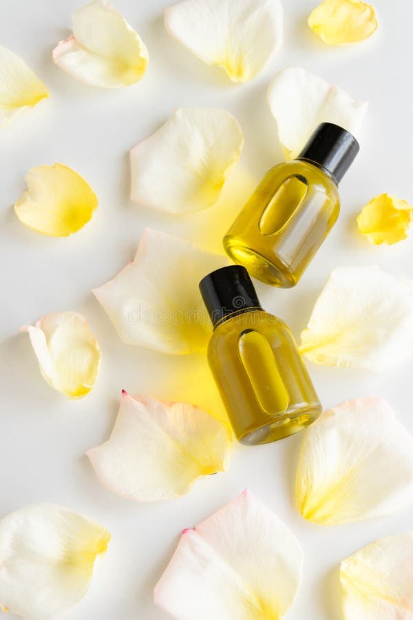 Essential oil with rose petals. Hygiene product. Body, face lotion with wild flowers. Wellness therapy regeneration stock images Essential oil with rose petals. Hygiene product. Body, face lotion with wild flowers. Wellness therapy regeneration stock images