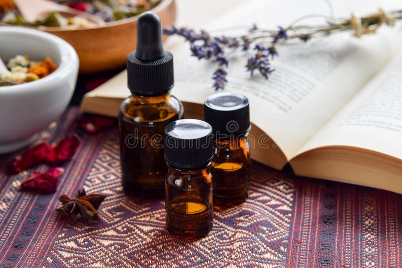 Essential oils with herbs and book