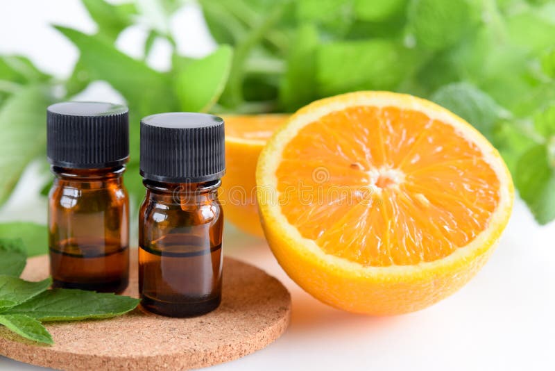 Essential oils with orange and mint stock photos Essential oils with orange and mint stock photos