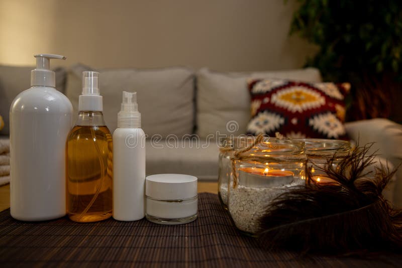 A beautifully arranged and serene display of various spa products and elegant candles for a calming home experience. Pampering experience stock images, royalty-free photos and pictures