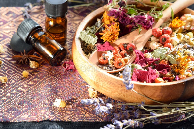 Essential oils with herbal flowers and dried herbs. Essential oils with herbal flowers and dried herbs