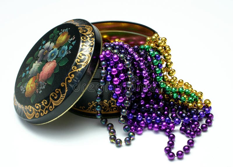 Vintage style, lidded tin canister with Mardi Gras beads overflowing, photographed on white. Vintage style, lidded tin canister with Mardi Gras beads overflowing, photographed on white