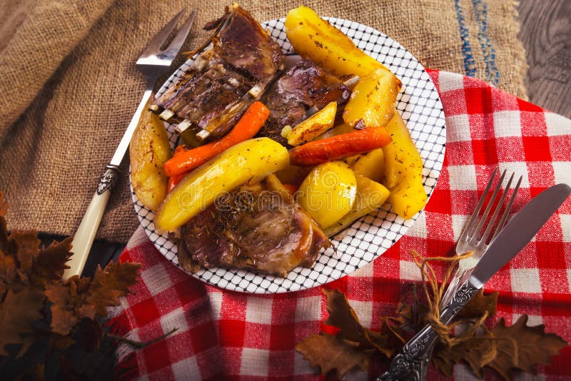 Estante asado a la parrilla de las tajadas de cordero con las patatas verduras fotografía de archivo Estante asado a la parrilla de las tajadas de cordero con las patatas verduras fotografía de archivo