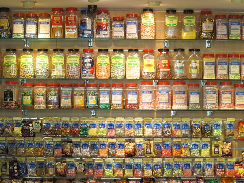 Colorful candy jars, cans and bags well-sorted in the shelves of a shop &#x28;merchandising in Australia&#x29;. Colorful candy jars, cans and bags well-sorted in the shelves of a shop &#x28;merchandising in Australia&#x29;