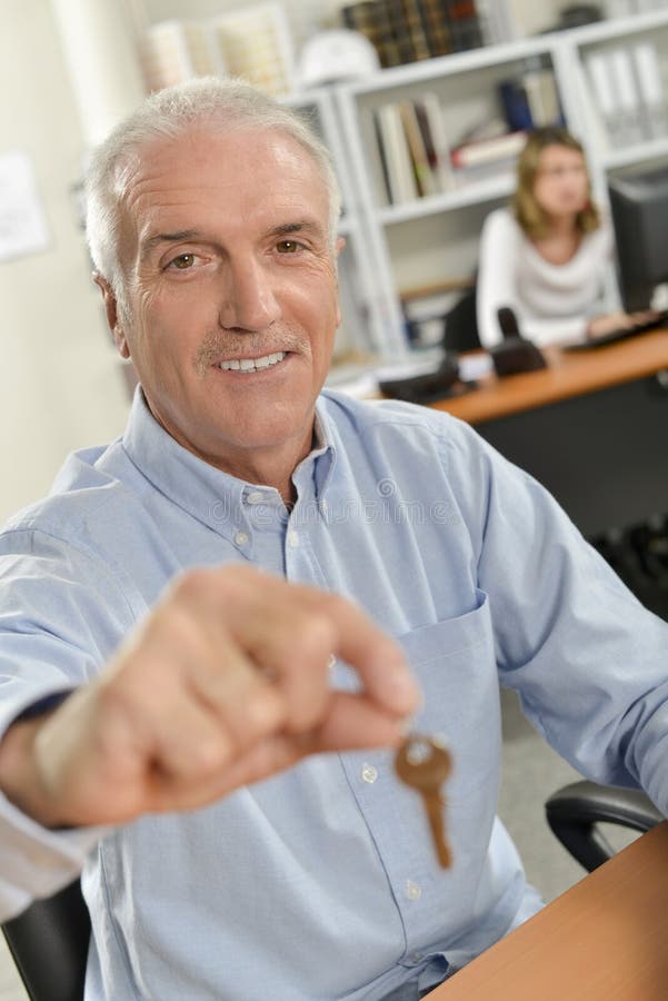 Estate Agent Holding Out Key Stock Photo Image of successful