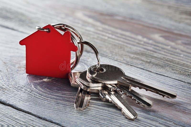 Estate concept with key, red keychain with house symbol