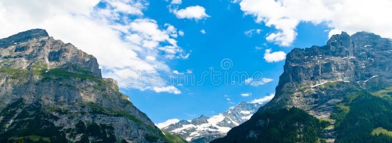 Bernese Alps - snow capped mountains and deep green valleys, stunning view, breathtaking panorama, Switzerland. Bernese Alps - snow capped mountains and deep green valleys, stunning view, breathtaking panorama, Switzerland