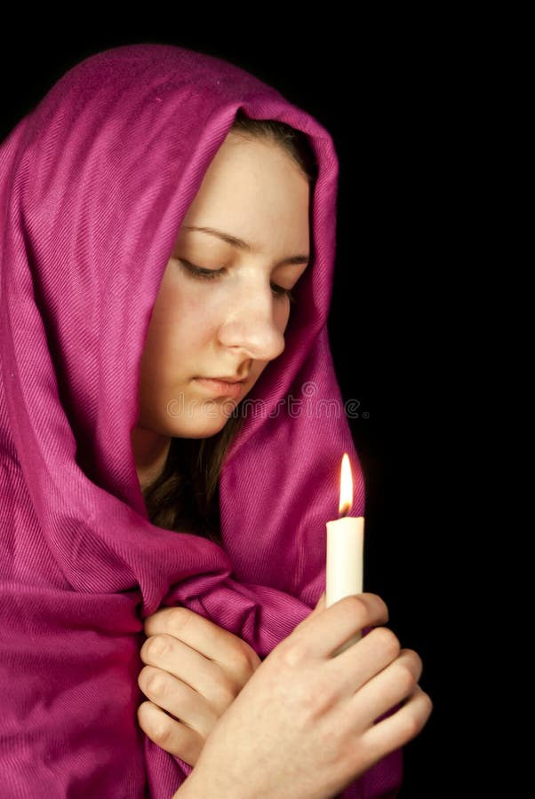 Eastern style dressed teen girl with a burning candle. Eastern style dressed teen girl with a burning candle