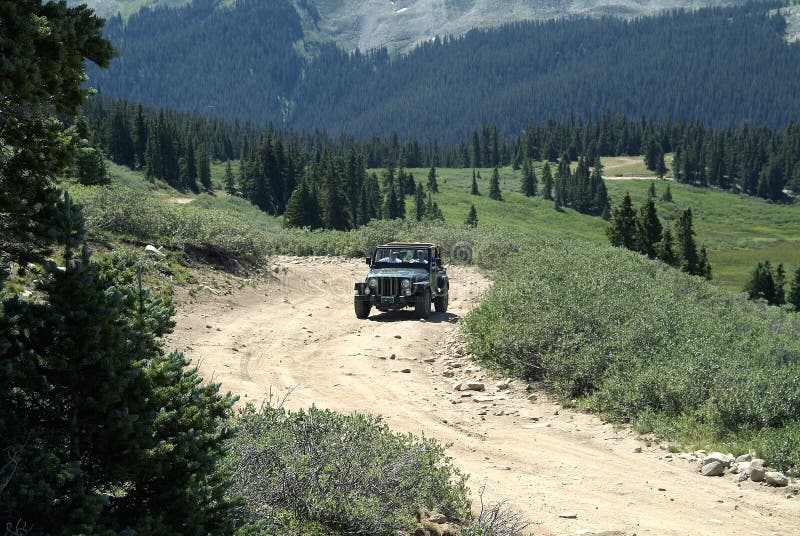 Jeep 4-wheeling down a gravel road. Jeep 4-wheeling down a gravel road