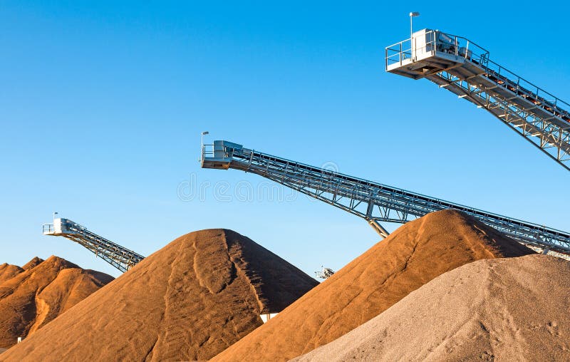 Conveyors and gravel heaps at an industrial Plant for mining of basic materials. Conveyors and gravel heaps at an industrial Plant for mining of basic materials