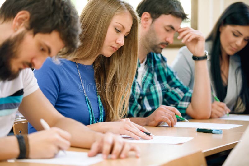 Young students having a test in a classroom. Young students having a test in a classroom