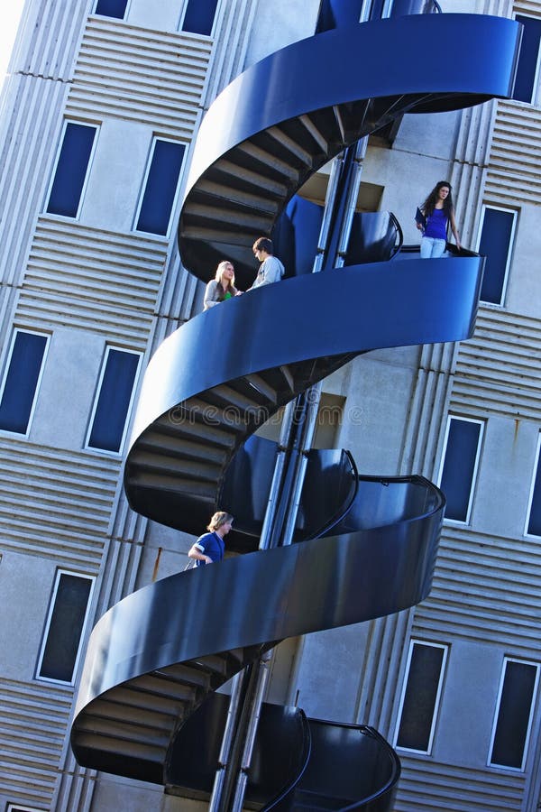 Estudiantes en escalera espiral de la universidad foto de archivo libre de regalías Estudiantes en escalera espiral de la universidad foto de archivo libre de regalías