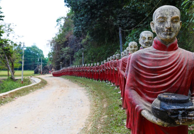 Statues of monks in robes collecting alms in the public park in Myanmar. Statues of monks in robes collecting alms in the public park in Myanmar