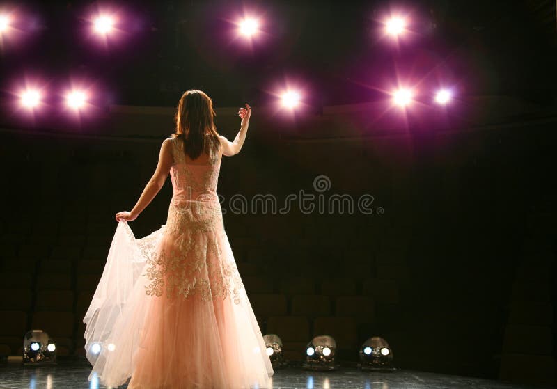 Girl in long gown performing on stage. Girl in long gown performing on stage