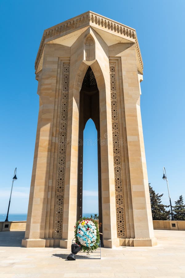 Baku, Azerbaijan - May 2, 2019. Eternal Flame Memorial, composed of a tomb standing on an 8-pointed star crown with a gold-framed glass dome, at the Alley of Martyrs in Baku. The Alley of Martyrs is a cemetery and memorial in Baku, Azerbaijan dedicated to those killed by the Soviet Army during Black January 1990 and in the Nagorno-Karabakh War of 1988–1994