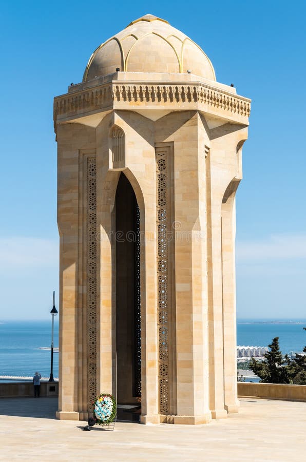 Baku, Azerbaijan - May 2, 2019. Eternal Flame Memorial, composed of a tomb standing on an 8-pointed star crown with a gold-framed glass dome, at the Alley of Martyrs in Baku. The Alley of Martyrs is a cemetery and memorial in Baku, Azerbaijan dedicated to those killed by the Soviet Army during Black January 1990 and in the Nagorno-Karabakh War of 1988–1994