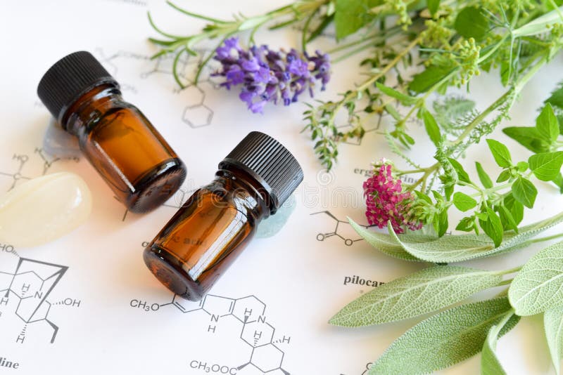 Essential oils with herbs on science background. Essential oils with herbs on science background