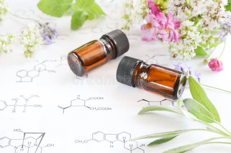 Essential oils on science sheet with herbs. Essential oils on science sheet with herbs