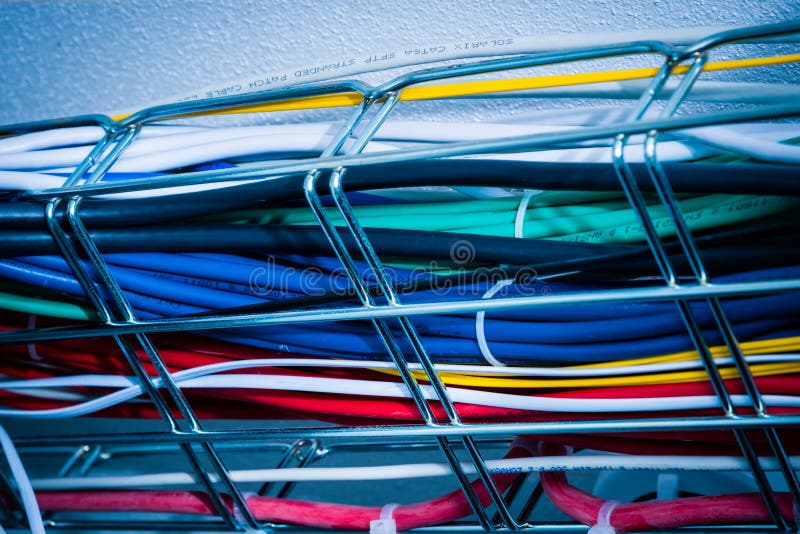 Ethernet cables in a cable guard leading along the ceiling insid stock photography