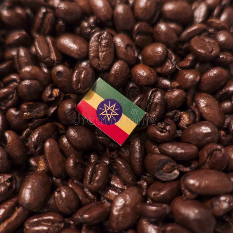 A Ethiopia flag placed over roasted coffee beans royalty free stock photos