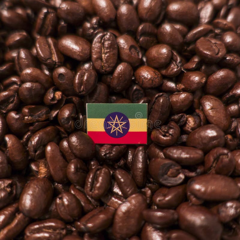 A Ethiopia flag placed over roasted coffee beans royalty free stock image