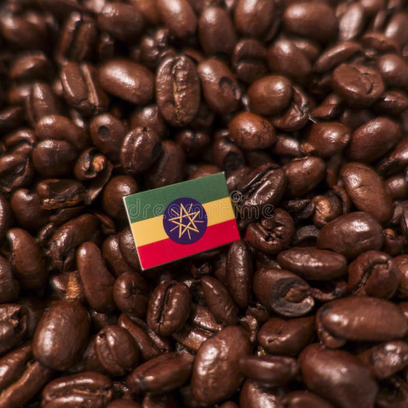 A Ethiopia flag placed over roasted coffee beans stock photo