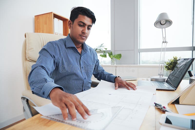 Ethnic engineer working in office stock image Ethnic engineer working in office stock image