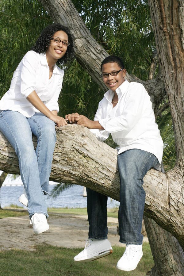 Ethnic teens in tree