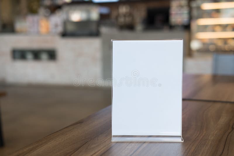 white label in cafe. display stand for acrylic tent card in coffee shop. mockup menu frame on table in bar restaurant. space for text. white label in cafe. display stand for acrylic tent card in coffee shop. mockup menu frame on table in bar restaurant. space for text