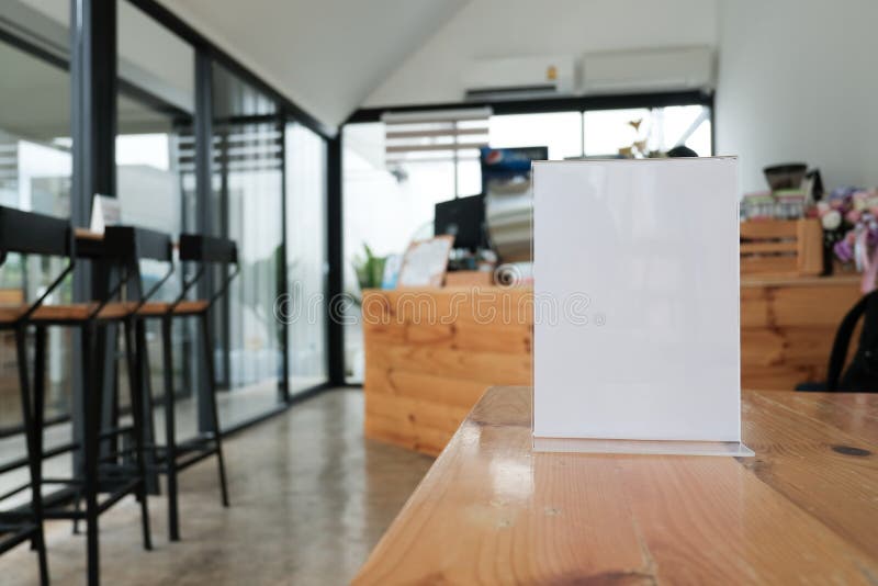 white label in cafe. display stand for acrylic tent card in coffee shop. mockup menu frame on table in bar restaurant. space for text. white label in cafe. display stand for acrylic tent card in coffee shop. mockup menu frame on table in bar restaurant. space for text