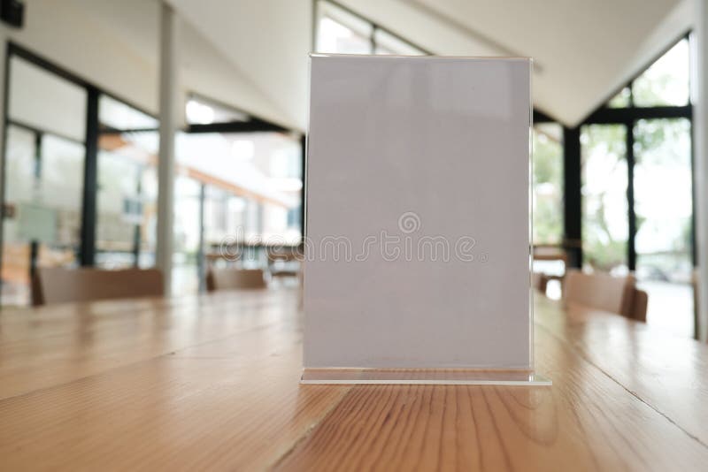white label in cafe. display stand for acrylic tent card in coffee shop. mockup menu frame on table in bar restaurant. space for text. white label in cafe. display stand for acrylic tent card in coffee shop. mockup menu frame on table in bar restaurant. space for text