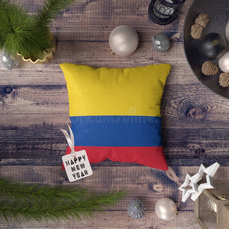 Etichetta del buon anno con la bandiera della Colombia sul cuscino Concetto della decorazione di Natale sulla tavola di legno con fotografia stock libera da diritti Etichetta del buon anno con la bandiera della Colombia sul cuscino Concetto della decorazione di Natale sulla tavola di legno con fotografia stock libera da diritti