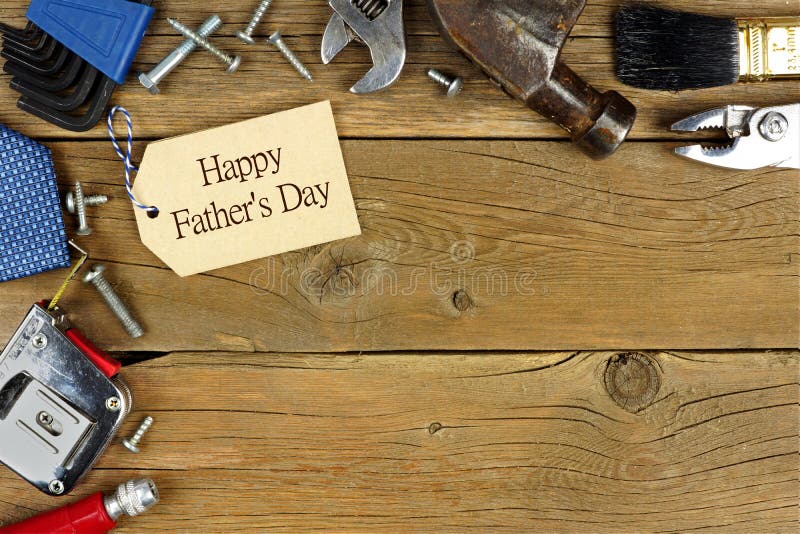 Happy Fathers Day tag and corner border of tools on rustic wood background. Happy Fathers Day tag and corner border of tools on rustic wood background