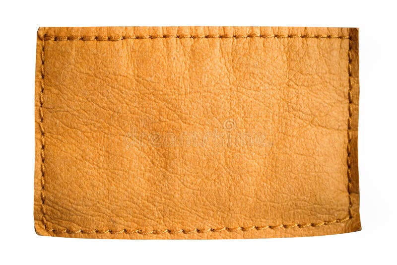 Etiqueta de couro da etiqueta das calças de brim da placa em claro - cor amarela marrom com o espaço vazio claro para o texto ou
