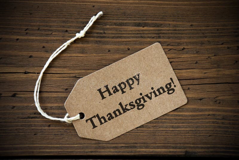 Rustic Natural Label with the Words Happy Thanksgiving on it on Wooden Background. Rustic Natural Label with the Words Happy Thanksgiving on it on Wooden Background