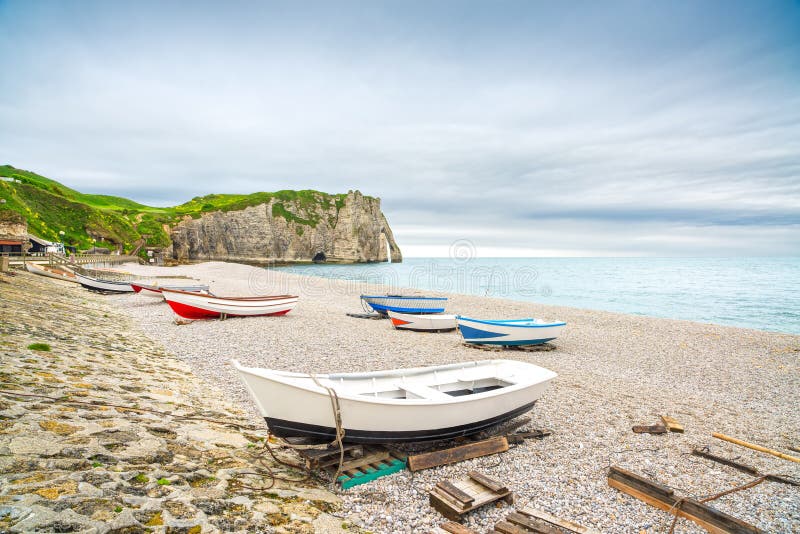 Etretat village, its bay beach, Aval cliff and boats. Normandy, France, Europe. Etretat village, its bay beach, Aval cliff and boats. Normandy, France, Europe.