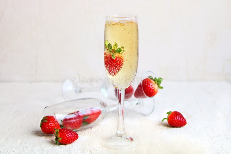 Ett crystal exponeringsglas av champagne med nya jordgubbar arkivfoton Ett crystal exponeringsglas av champagne med nya jordgubbar arkivfoton