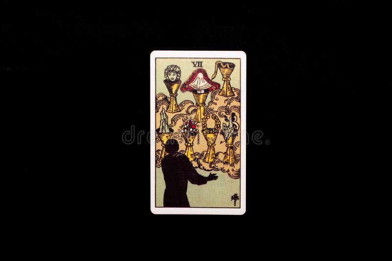 A front shot of a tarot card isolated on black background. Can be used as a design asset or as a background. Seven of cups. A front shot of a tarot card isolated on black background. Can be used as a design asset or as a background. Seven of cups.