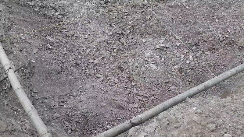 Ett nära skott av golvet i marken görs i rörnivå med bambu på en byggplats i indo-tubelevel