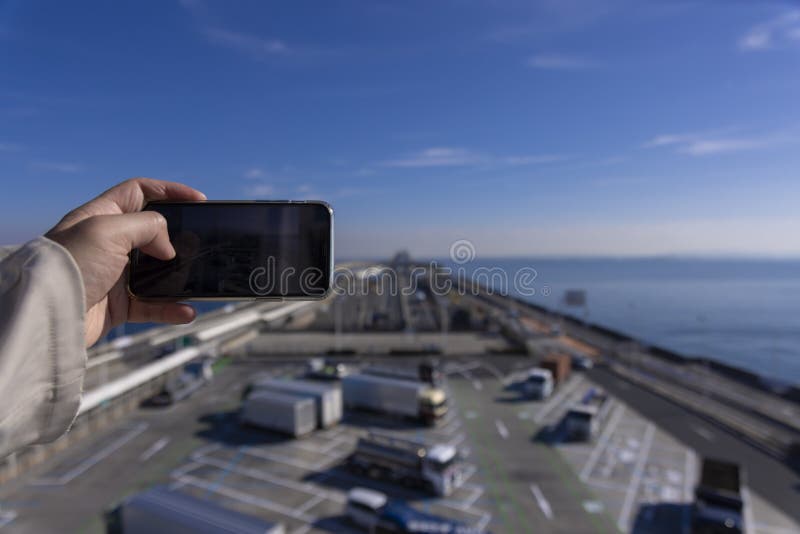 A traffic jam shooting by smartphone on the highway at Tokyo bay area in Chiba. High quality photo. Kisarazu district Chiba Japan 01.30.2024 Here is the highway parking called UMIHOTARU PA in Chiba. A traffic jam shooting by smartphone on the highway at Tokyo bay area in Chiba. High quality photo. Kisarazu district Chiba Japan 01.30.2024 Here is the highway parking called UMIHOTARU PA in Chiba