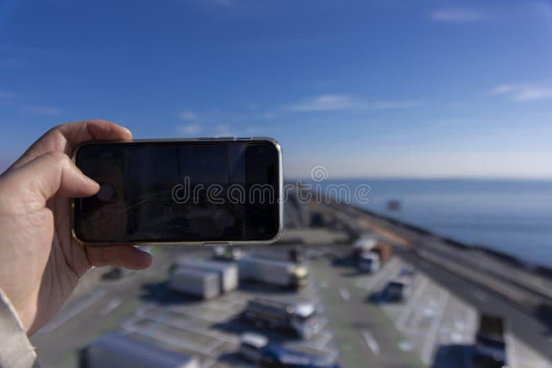 A traffic jam shooting by smartphone on the highway at Tokyo bay area in Chiba. High quality photo. Kisarazu district Chiba Japan 01.30.2024 Here is the highway parking called UMIHOTARU PA in Chiba. A traffic jam shooting by smartphone on the highway at Tokyo bay area in Chiba. High quality photo. Kisarazu district Chiba Japan 01.30.2024 Here is the highway parking called UMIHOTARU PA in Chiba