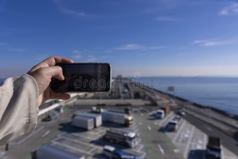 A traffic jam shooting by smartphone on the highway at Tokyo bay area in Chiba. High quality photo. Kisarazu district Chiba Japan 01.30.2024 Here is the highway parking called UMIHOTARU PA in Chiba. A traffic jam shooting by smartphone on the highway at Tokyo bay area in Chiba. High quality photo. Kisarazu district Chiba Japan 01.30.2024 Here is the highway parking called UMIHOTARU PA in Chiba