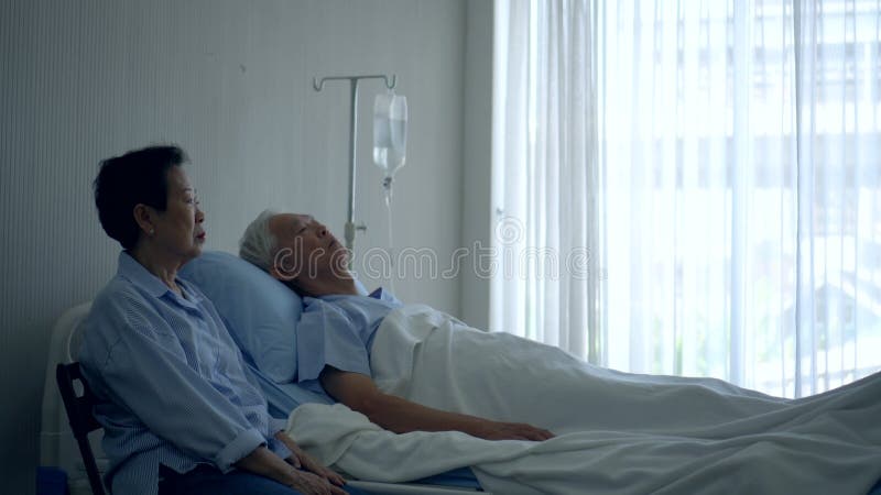 Ett äldre högt par som väntar på att läkaren ska bli ledsen och nedstämd arkivfilmer
