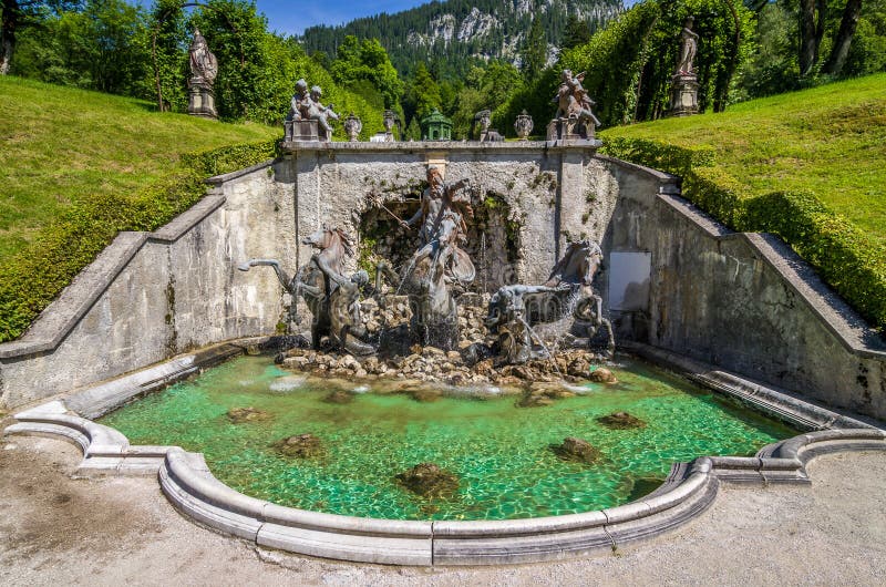 Cascade with Neptune fountain in Linderhof Park Bavaria, Germany. Linderhof Palace was one of the three palaces built by King Ludwig II of Bavaria. Cascade with Neptune fountain in Linderhof Park Bavaria, Germany. Linderhof Palace was one of the three palaces built by King Ludwig II of Bavaria