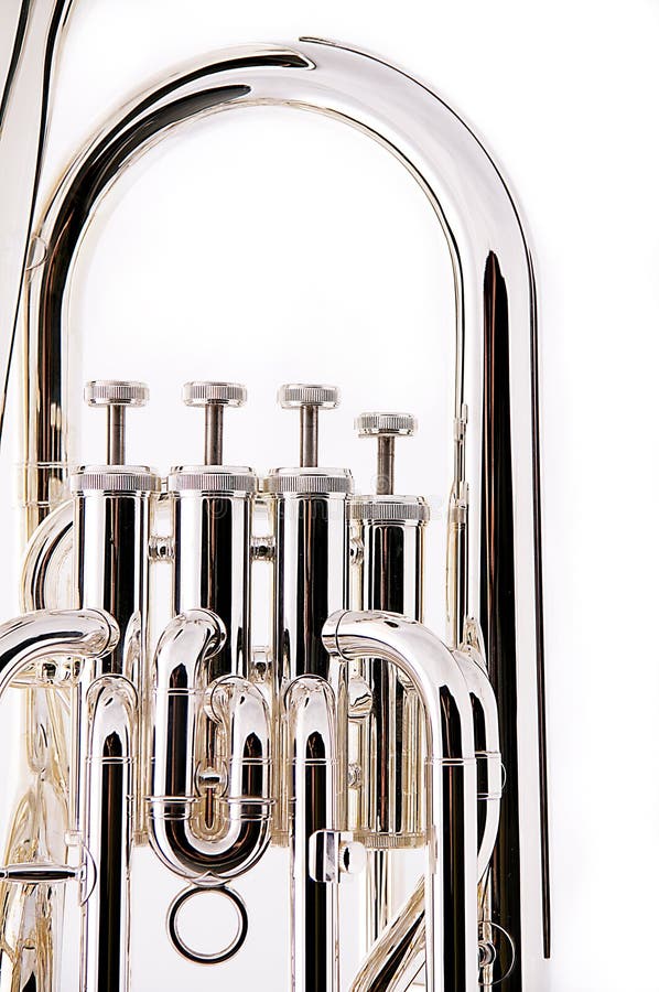 A silver bass tuba euphonium against a white background in the vertical format with copy space. A silver bass tuba euphonium against a white background in the vertical format with copy space.