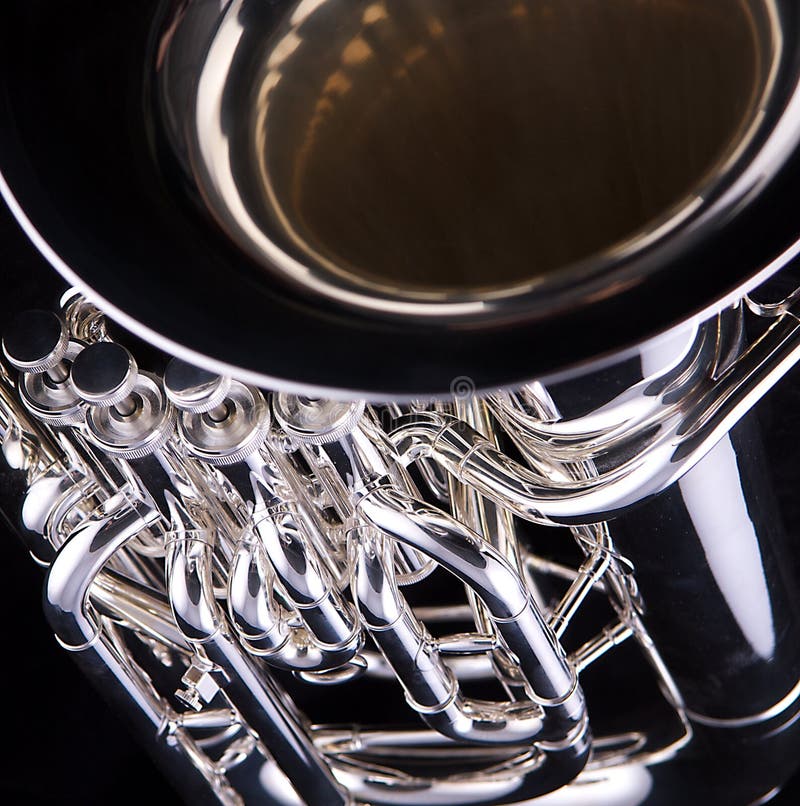 A silver tuba euphonium isolated on a black background in the square format. A silver tuba euphonium isolated on a black background in the square format.