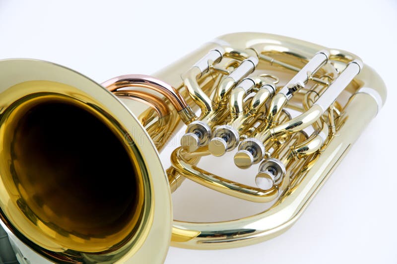 A gold brass tuba or euphonium isolated against a high key white background in the horizontal format. A gold brass tuba or euphonium isolated against a high key white background in the horizontal format.