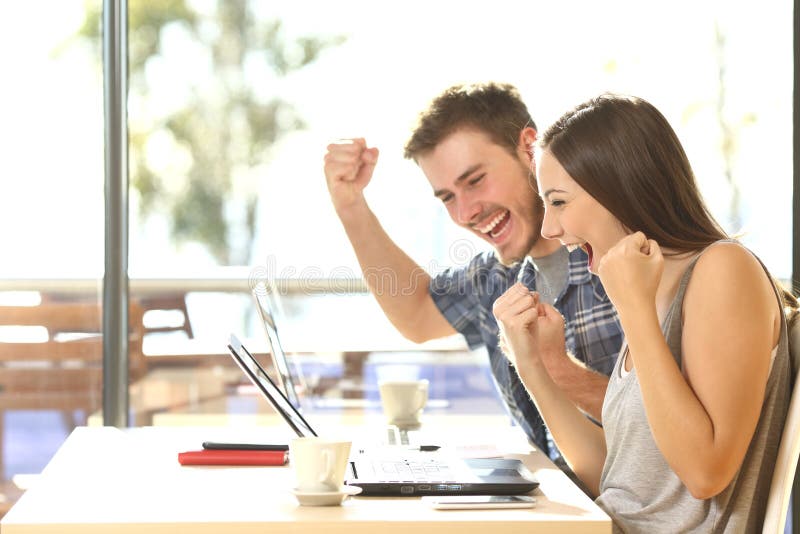 Euphoric students watching exam results stock image