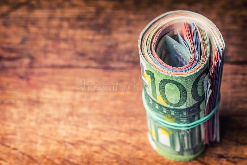 Euro banknotes. Euro currency. Euro money. Close-up Of A Rolled Euro Banknotes On concrete or Wooden table. Exchange, closeup.